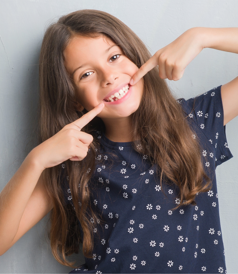 Young girl smiles as she just got her new Invisalign in NYC